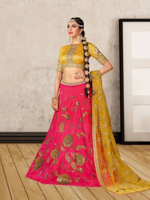 Earn Lots Of Compliments Wearing This Designer Lehenga Choli In Musturd Yellow Colored Blouse Paired With Contrasting Dark Pink Colored Lehenga And Musturd Yellow Colored Dupatta. This Lehenga Choli Is Fabricated On Art Silk Paired With Net Fabricated Dupatta. It Has Designer Embroidery Over The Lehenga And Blouse And Also It Is Comfortable To Carry All Day Long.