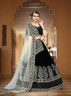Enhance Your Beauty Wearing This Lehenga Choli In black Color Paired With White Colored Dupatta. This designer Lehenga Choli Is Fabricated On Velvet Paired With Net Fabricated Dupatta. It Is Beautified With Attractive Embroidery All Over It. Buy This Lehenga Choli Now.