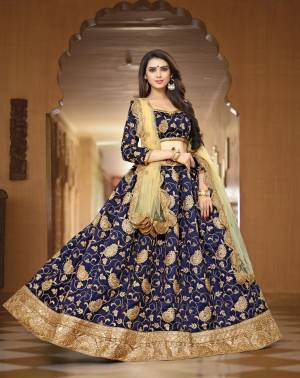 For A Heavy And Designer Look, Grab This Lehenga Choli In Navy Blue Color Paired With Beige Colored Dupatta. This Lehenga Choli Is Fabricated On Art Silk Paired With Net Fabricated Dupatta. It Is Beautified With Jari Embroidery All Over It. Buy Is Soon Before The Stock Ends.
