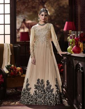 Grab This Beautiful Designer Suit In Beige Color Paired With Beige colored Bottom And Dupatta. Its Top Is Fabricated On Net Paired With Santoon Bottom And Chiffon Dupatta.  This Suit Is Beautified With Black Colored embroidery Over The panel And Golden Embroidered Patch Work. Buy This Suit now.