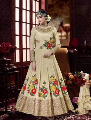 Fashion Keeps On Changing And So Do You, So Go With the Lastest Tredn With This Designer Floor Length Suit In Cream Colore Paired With Cream Colored Bottom And Dupatta. Its Top Is Fabricated On Art Silk Paired With Santoon Bottom And Chiffon Dupatta. It Has Contrasting Colored Embroidery Which Is Making It More Attractive.