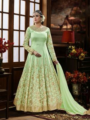 Here Is A Beautiful Shade Of Green With This Designer Floor Length Suit In Pastel Green Color Paired With Pastel Green Colored Bottom And Dupatta. It Is Beautified With Heavy Jari Embroidery And Stone Work. It Ensures Superb Comfort Throughout The Gala. Buy Now.