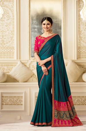 New And Unique Shade Of Blue Is Here With This Teal Blue Colored Saree Paired With Contrasting Dark Pink Colored Blouse. This Saree Is Fabricated On Silk Paired With Art Silk Fabricated Blouse. Both Fabrics Are Soft Towards Skin And Easy To Carry All Day Long. 