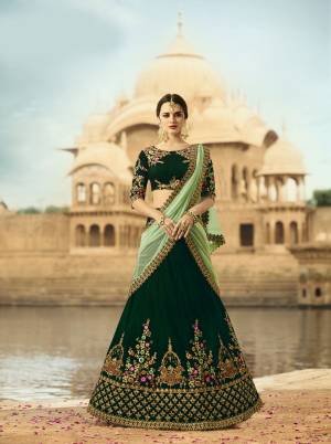 Earn Lots Of Compliments Wearing this Designer Lehenga Choli In Shades Of Green. Grab This Lehenga Choli In Dark Green Color Paired With Pastel green Colored Dupatta. This Lehenga and Choli Are Fabricated On Velvet Paired With Net Fabricated Dupatta. This Lehenga Choli Ensures Superb Comfort Throughout The Gala. Buy It Now.