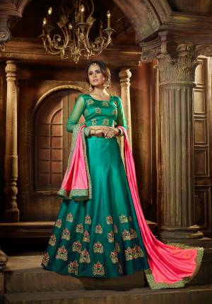 Go With The Pretty Shades Of Green With This Designer Lehenga Choli In Teal Green Color Paired With Contrasting Pink Colored Dupatta. Its Blouse Is Fabricated On Art Silk Paired With Satin Silk Lehenga And Satin Fabricated Dupatta. It Has Attractive Embroidered Buttas Over The  Lehenga And Blouse. Buy It Now.