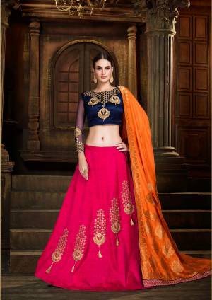 Go Colorful Wearing This Lehenga Choli In Navy Blue Colored Blouse Paired With Dark Pink Colored Lehenga And Contrasting Orange Colored Dupatta. Its Blouse And Lehenga Are Fabricated On Art Silk Paired With Silk Jacquard Fabricated Dupatta. Its Fabrics Gives A Rich To Your Personality Which Will earn You Lots Of Compliments From Onlookers.