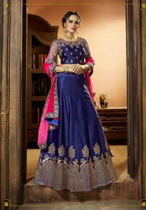 Shine Bright At The Next Wedding You Attend Wearing This Lehenga Choli In Blue Color Paired With Contrasting Rani Pink Colored Dupatta. Its Blouse Is Fabricated On Art Silk Paired With Satin Silk Lehenga And Chiffon Dupatta. It Is Light In Weight And Easy To Carry All Day Long.  