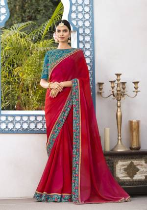 Adorn The Angelic look Wearing This Saree In Red Color Paired With Contrasting Blue Colored Blouse. This Pretty Saree Is Fabricated  Georgette Paired With Art Silk Fabricated Blouse. It Has Attractive Embroidery Over The Blouse And Lace Border.