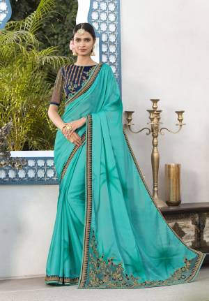 Go With The Shades Of Blue With This Saree In Blue Color Paired With Navy Blue Colored Blouse. This Saree Is Fabricated On Chiffon Paired With Art Silk Fabricated Blouse. It Has Lovely Embroidery Over The Blouse And Saree Border.