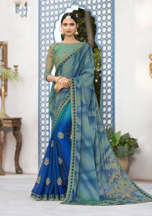 A Very Lovely And Unique Shaded Saree Is Here In Shades Of Blue Paired With Contrasting Sea Green Colored Blouse. This Saree Is Fabricated On Georgette Paired With Art Silk Fabricated On It Is Soft towards Skin And Easy To Carry All Day Long.