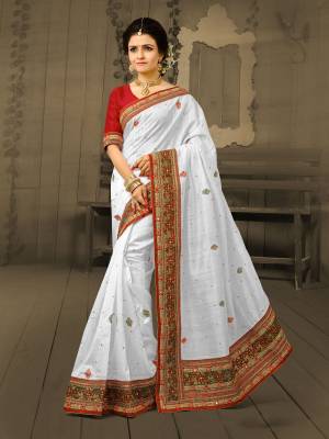Simple And Ellgant Looking Saree IS Here With This Saree In White Color Paired With Red Colored Blouse. This Saree And Blouse Are Fabricated On Art Silk Which Is Durable and Easy To Drape. Buy This Pretty Elegant Saree Now.