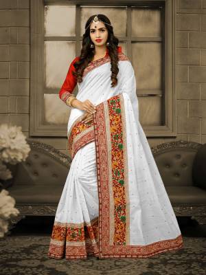 Simple And Ellgant Looking Saree IS Here With This Saree In White Color Paired With Red Colored Blouse. This Saree And Blouse Are Fabricated On Art Silk Which Is Durable and Easy To Drape. Buy This Pretty Elegant Saree Now.