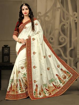 If You Are Fond Of Folk Prints, Than Grab This Designer Saree In Off-White Color Paired With Maroon Colored Blouse. This Saree Is Fabricated On Art Silk Paired With Art Silk Fabricated Blouse. It Is Beautified With Folk Embroidery Over The Panel. Buy This Designer Saree Now.