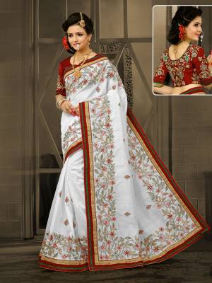 Celebrate This Festive Season Wearing This Saeee In White Color Paired With Rich Maroon Colored Blouse. This Saree Is Fabricated On Soft Art Silk Paired Wuth Art Silk Fabricated Blouse. It Has Beautiful Attractive Embroidery All Over The Saree.