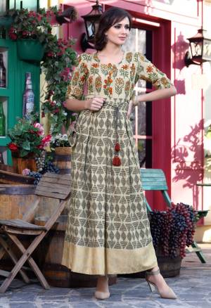 Another Beige Colored Designer Readymade Kurti Is Here Fabricated On Cotton Beautified With Prints All Over. This Kurti Is Light In Weight And Eays To Carry All Day Long.