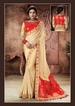Catch the captivating essence of the Indian culture in this traditional cream-red saree . Pair it with statement chandbalis  and you are all set for the function. 