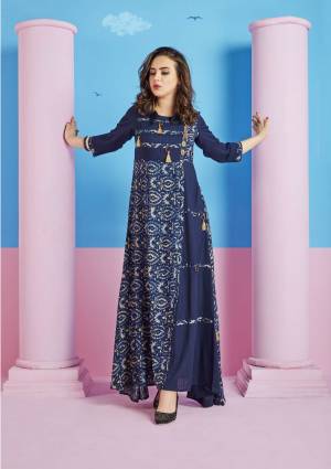 Grab This Long Designer Kurti In Navy Blue Color Fabriacted On Rayon Cotton. This Kurti Is Beautified With Prints. It Is Light In Weight And Easy To Carry All Day Long. 