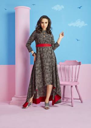 Grab This High Low Patterned Kurti In Dark Grey Color Fabricated On Rayon Cotton. It Is Beautified with Abstract Paisly Prints All Over It. This Kurti Is Light Weight And Easy To Carry All Day Long. 