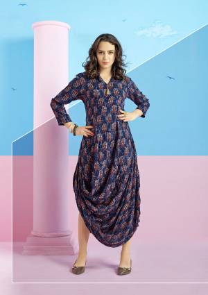 New And Unique Drape Patterned Designer Kurti Is Here In Navy Blue Color.Grab This Pretty Kurti Fabricated On Rayon Cotton Beautified With Prints. This Kurti Will Definitely Earn You Lots Of Compliments From Onlookers.