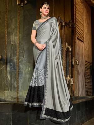 Attractively Gorgeous mesmerizing is what you will look at the next wedding gala wearing this beautiful grey and black color bright georgette and net heavy work lycra pattern saree. Ideal for party, festive & social gatherings. this gorgeous saree featuring a beautiful mix of designs. Its attractive color and designer patch, stone, floral design work over the attire & contrast hemline adds to the look. Comes along with a contrast unstitched blouse.
