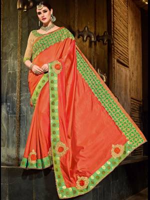 Get this amazing saree  and look pretty like never before. wearing this orange color two-tone silk fabrics saree. Ideal for party, festive & social gatherings. this gorgeous saree featuring a beautiful mix of designs. Its attractive color and designer patch, stone, floral design work over the attire & contrast hemline adds to the look. Comes along with a contrast unstitched blouse.