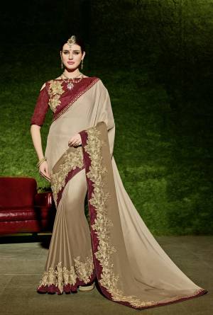Look gorgeous in this beautiful printed beige color shaded bright georgette saree. Ideal for party, festive & social gatherings. this gorgeous saree featuring a beautiful mix of designs. Its attractive color and designer floral design, stone work over the attire & contrast hemline adds to the look. Comes along with a contrast unstitched blouse.