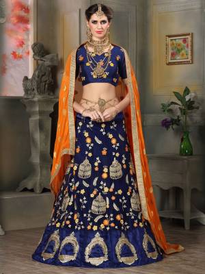 You Will Definitely Earn Lots Of Compliments Wearing This Designer Lehenga Choli In Navy Blue Color Paired With Contrasting Orange Colored Dupatta. Its Blouse Is Fabricated On Art Silk Paired With Net Lehenga And Chiffon Dupatta. Its Light Weight And Ensures Superb Comfort All Day Long. 