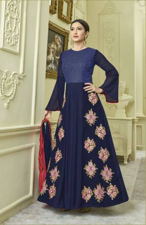 Another Designer Floor Length Suit Is Here In Navy Blue Color Paired With Navy Blue Colored Bottom And Dupatta. Its Top Is Fabricated On Georgette And Rayon Paired With Santoon Bottom And Chiffon Dupatta. Its Beautiful Bell Sleeve Pattern And Detailed Embroidery Will Earn You Lots Of Compliments From Onlookers,