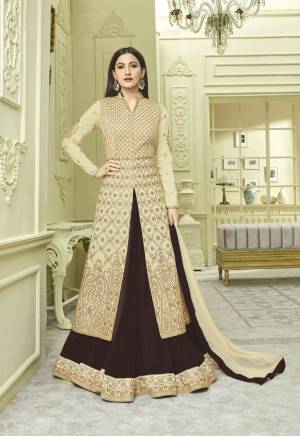 Flaunt Your Rich and Elegant Taste Wearing This Indo-Western Suit In Beige Colored Top Paired With Brown Colored Lehenga And Beige Colored Dupatta. Its Top Is Fabricated On Art Silk Paired With Net Lehenga And Chiffon Dupatta. Buy This Designer Suit Now.