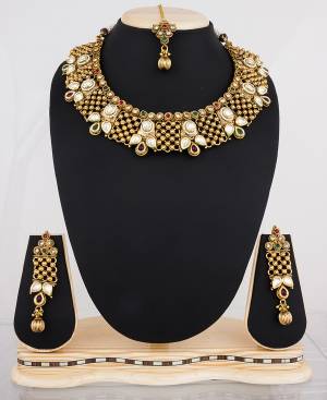 Choker Patterned Necklace Set Is Here With This Beautiful Designer Necklace Set In Golden Color Beautified With Multi Colored Stones. Buy It Now.
