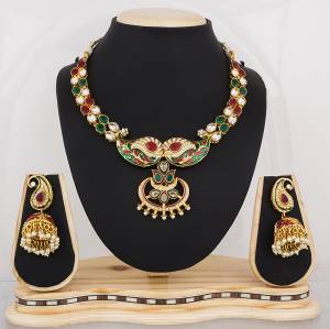 Proper Traditional Necklace set Is Here With Golden Colored Base Beautified With Multi Colored Stone Work. It Is Light Weight And Easy To carry Throughout The Gala.