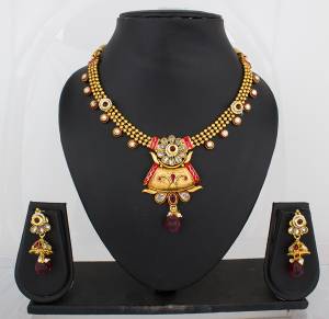 Here Is A Beautiful Traditonal Necklace Set In Golden Color Beautified With Maroon Colored Stones. This Necklace Set Can Be Paired With Any Contrasting Colored Traditional Attire.