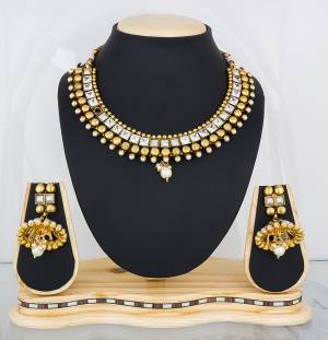 Earn Lots Of Compliments Wearing This Attractive Necklace Set In Golden Color Beautified with White Colored Stone Work. This Can be Paired With Navy Blue Or Any Contrasting Colored Attire. Buy Now.