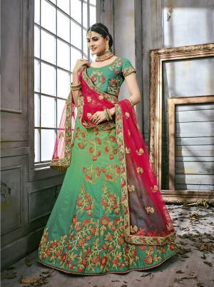 Here Is A Very Pretty Shade Of Green With This Designer Lehenga Choli In Sea Green Color Paired With Contrasting Dark Pink Colored Dupatta. Its Lehenga And Choli Are Fabricated On Satin Silk Paired With Net Fabricated Dupatta. It Has Attractive Embroidery All Over It. Buy This Lehenga Choli Now. 