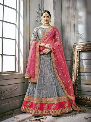 Flaunt Your Rich And Elegant Taste Wearing This Lehenga Choli In Grey Color Paired With Contrasting Pink Colored Dupatta. Its Blouse Is Fabricated On Satin Silk Paired With Net Lehenga And Net Dupatta. Its Unique Color Combination And Embroidery Will Earn You Lots Of Compliments From Onlookers. Buy Now.
