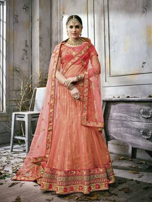 This Wedding Season, Catch All The Lime Light Wearing This Designer Lehenga Choli In Pink Colored Blouse Paired With Contrasting Peach Colored Lehenga And Dupatta. Its Blouse Is Fabricated On Art Silk Paired With Net Fabricated Lehenga And Dupatta. It Is Light In Weight And Easy To Carry Throughout The Gala.