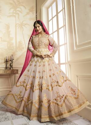 Flaunt Your Rich And Elegant Taste Wearing This Lovely Off-White Colored Designer Floor Length Suit Paired With Off-White Colored Bottom And Contrasting Pink Colored Dupatta. Its Top Is Fabricated On Georgette Paired With Santoon Bottom And Chiffon Dupatta. It HAs Heavy Embroidery All Over The Top. Buy This Suit Now.