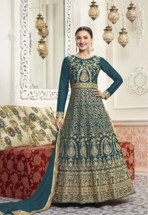 Here Is A New Shade Of Blue Which Will Give A Unique Look To Your Personality. Grab This Designer Floor Length Suit In Teal Blue Color Paired With Teal Blue Colored Bottom And Dupatta. Its Top Is Fabricated On Art Silk Paired With Santoon Bottom And Chiffon Dupatta. It Has Heavy Jari Embroidery All Over The Top. Buy This Designer Suit Now.
