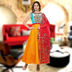 Go Colorful Wearing This Gown In Yellow And Sky Blue Color Paired With Contrasting Red Colored Dupatta. Its Top Is Fabricated On Art Silk Paired With Net Fabricated Dupatta. Buy This Gown Now.