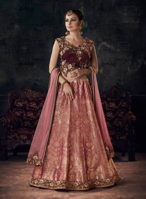 Here Is A Beautiful Designer Piece Which Will Earn You Lots Of Compliments From Onlookers. Grab This Designer Lehenga Choli In Maroon Colored Blouse Paired With Pink Colored Lehenga And Dupatta. Its Blouse Is Fabricated On Velvet Paired With Jacquard Silk Lehenga And Lycra Net Fabricated Dupatta. 
