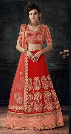 Adorn The Lovely Angelic Look Wearing This Red Colored Lehenga Choli Paired With Contrasting Peach Colored Dupatta. Its Lehenga And Choli Are Fabricated On Art Silk Paired With Net Fabricated Dupatta. This Lehenga Choli Will Definitely Earn You Lots Of Compliments From Onlookers.