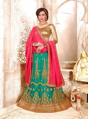 New Shades Are Here With This Pretty Lehenga Choli In Golden Colored Blouse Paired With Sea Green Colored Lehenga And Contrasting Old Rose Pink Colored Dupatta. Its Blouse Is Fabricated On Gota Silk Paired With Net Lehenga And Chiffon Dupatta. 