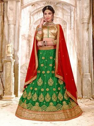 Pure Traditional Combination Is Here With This Lehenga Choli In Golden Colored Blouse Paired With Green Colored Lehenga And Contrasting Red Colored Dupatta. Its Blouse Is Fabricated On Gota Silk Paired With Net Lehenga And Chiffon Dupatta. Buy This Lehenga Choli Now.