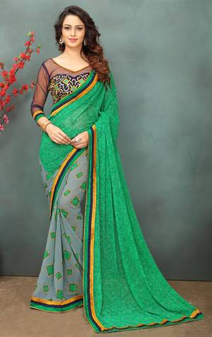 For Your Semi-Casual Wear, Grab This Saree In Green and Grey Color Paired With Navy Blue Colored Blouse. This Saree Is Fabricated On Georgette Paired With Art Silk And Net Fabricated Blouse. Saree Is Beautified With Prints And Blouse With Thread Embroidery.
