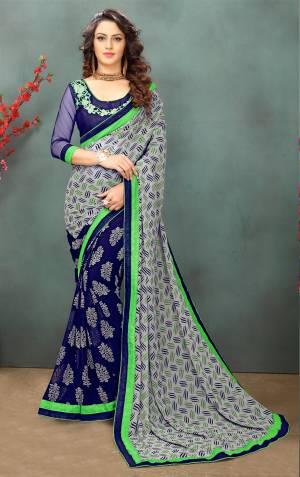 Add This Saree To Your Wardrobe In Grey and Navy Blue Color paired With Navy Blue Colored Blouse. This Saree Is Fabricated On Georgette Paired With Art Silk And Net Fabricated Blouse. It Is Light In Weight And Easy To Carry All Day Long.