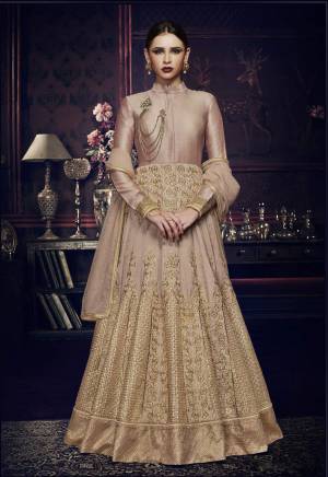 Add This Beautiful New Color To your Wardrobe In Heavy Dresses. Grab This Light Dusty Pink Colored Anarkali Floor Length Suit Paired With Light Dusty Colored Bottom And Dupatta. Its Top Is Fabricated On Art Silk Paired With Santoon Bottom And Lycra Dupatta. Buy This Designer Dress Now And You Will Definetily Earn Lots Of Compliments From Onlookers.