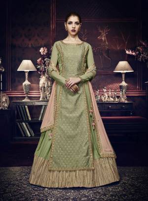 New And Unique Patterned Indo-Western Dress Is Here In Light Green Color Paired With Light Green Colored Bottom And Contrasting Peach Colored Dupatta. It Has  Designer Front Panel With Kalidar Georgette Inside. Its Top Is Fabricated On Georgette And Art Silk Paired With Santoon Bottom And Chiffon Dupatta. Buy This Designer Suit Now.