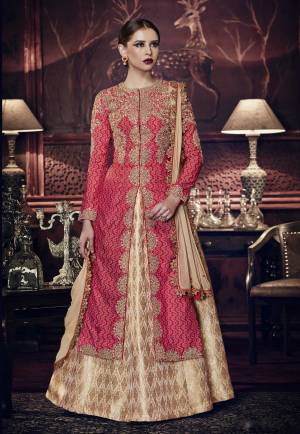 Another Lovely Designer Indo-Western Suit Is Here In Red Colored Top Paired With Beige Colored Lehenga And Dupatta. Its Top Is Fabricated On Printed Tussar Art Silk Paired With Brocade Lehenga And Chiffon Dupatta. It Is Beautified With Heavy Embroidery All Over The Top. Buy Now.