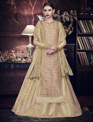 Elegant And Heavy Looking Indo-Western Suit Is Here In Beige Color Paired With Beige Colored Lehenga And Dupatta. Its Top Is Fabricated On Art Silk Paired With Brocade Lehenga And Jacquard Silk Dupatta. Its Rich Fabric And Color Will Make You Earn Lots Of Compliments From Onlookers.