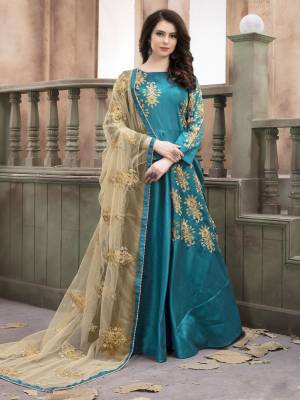 Celebrate This Festive Season Wearing This Designer Floor Length Suit In Turquoise Blue Colored Top Paired With Turquoise Blue Colored Bottom And Beige Colored Bottom. Its Top Is Fabricated On Art Silk Paired With Santoon bottom And Beige Colored Dupatta. It Is Beautified With Jari Embroidery And Stone Work. Buy Now.